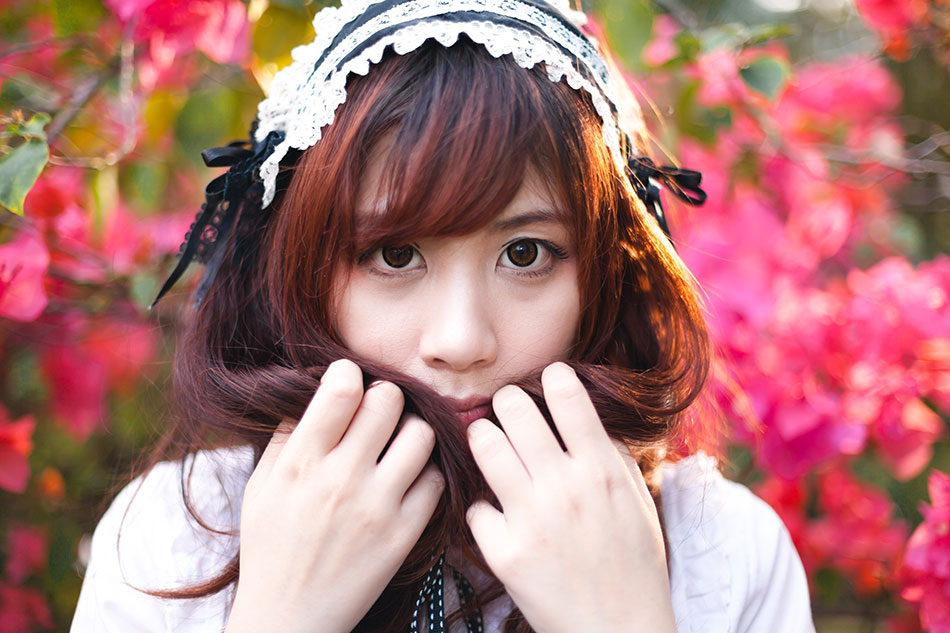 Asian woman in anime costume wearing circle lenses