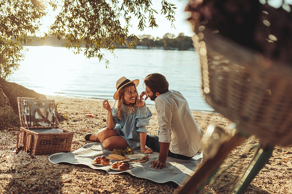 Couple with bike and picnic on the beach