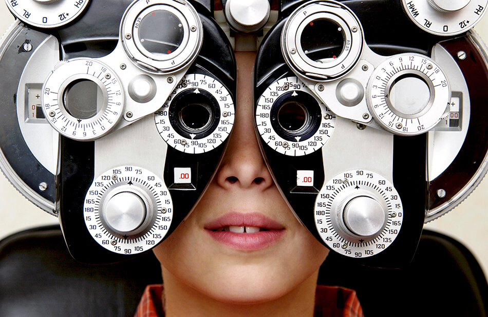 boy having the refraction test at an eye exam