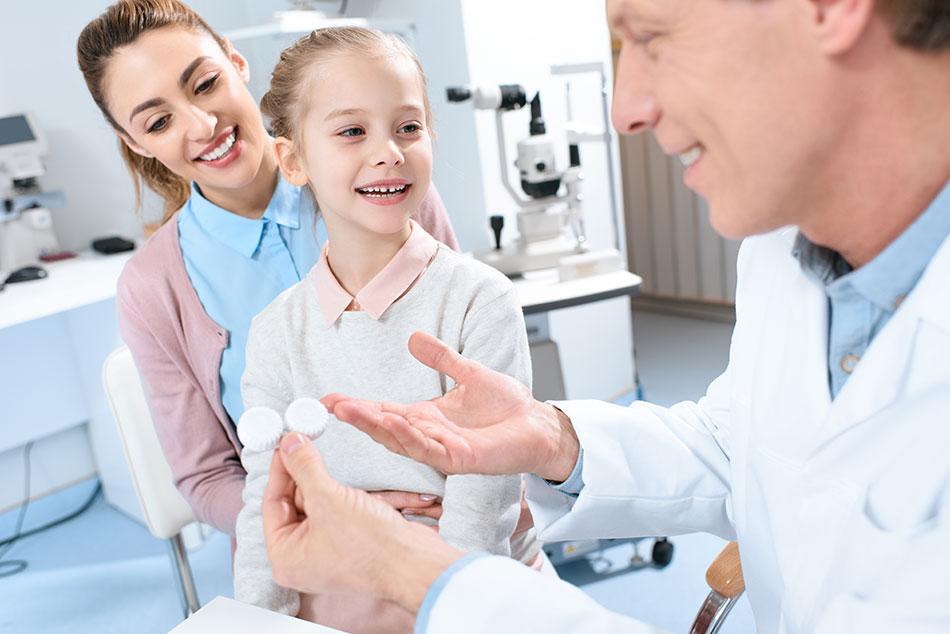 child with mother being taught proper contact lens care