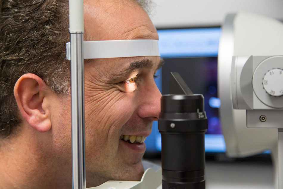 side view close-up of man having contact lens exam