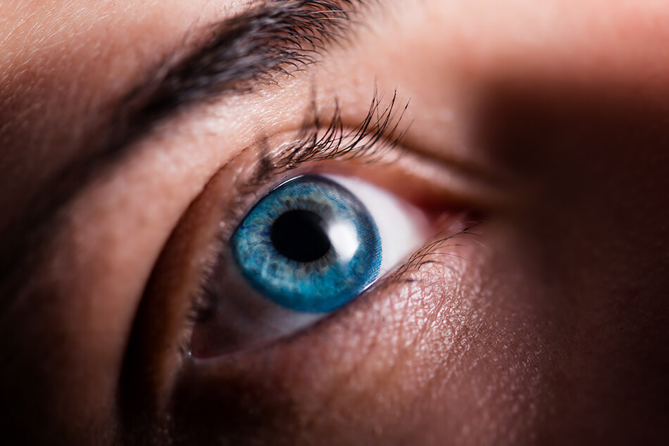 Close-up of woman's eye with a blue contact lens