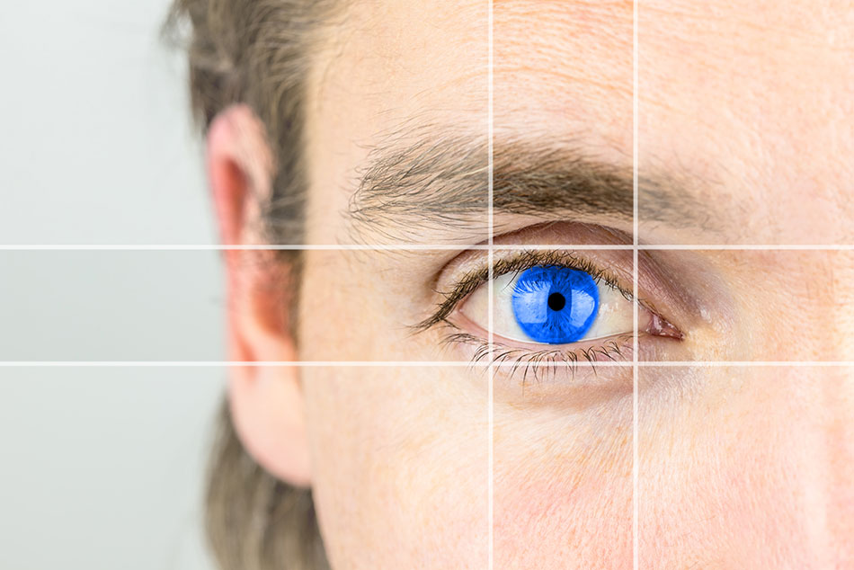 closeup of man’s eye with blue contact lens