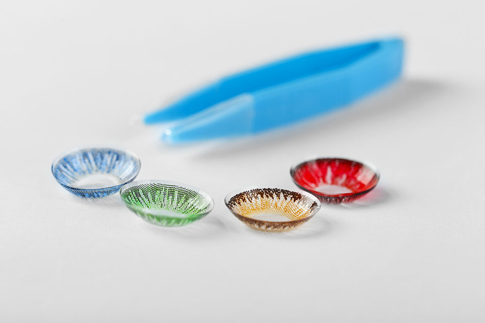 coloured contact lenses with a pair of blue tweezers