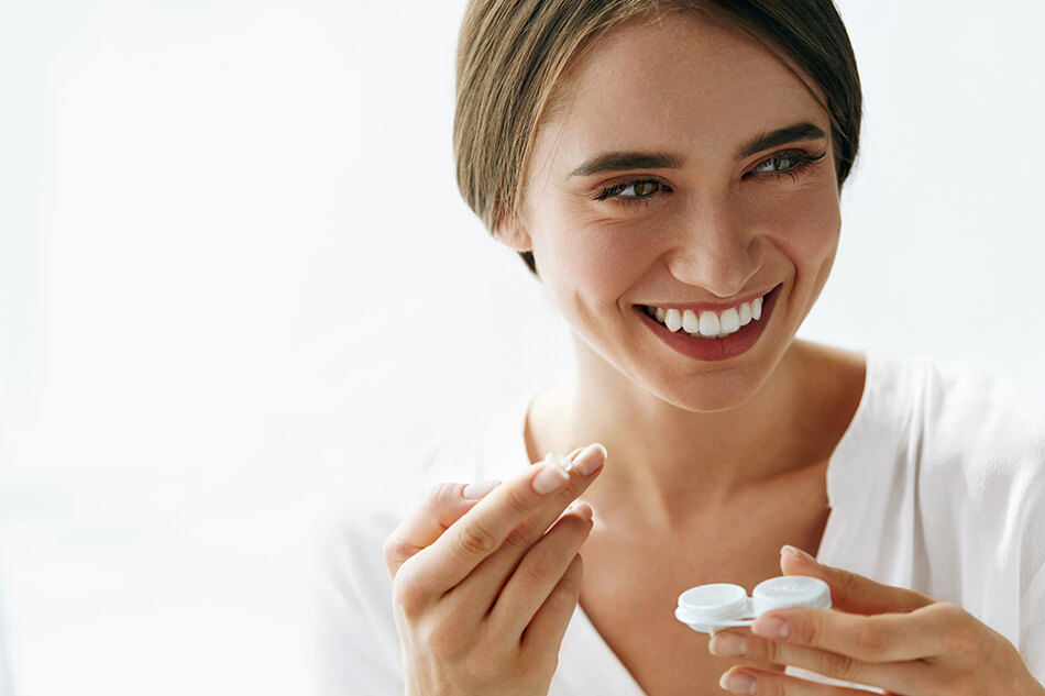 smiling woman practicing proper contact lens care, storage