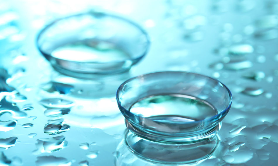 Contact lenses with water droplets on blue background