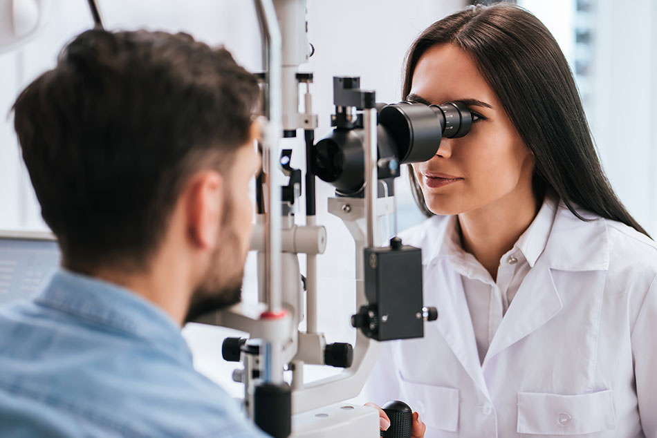 Female eye care professional conducting eye exam