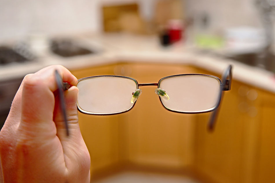 Fogged glasses with kitchen in background