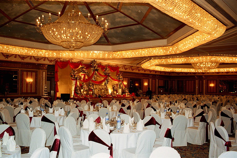 Formal hall with chandelier, white tables and chairs