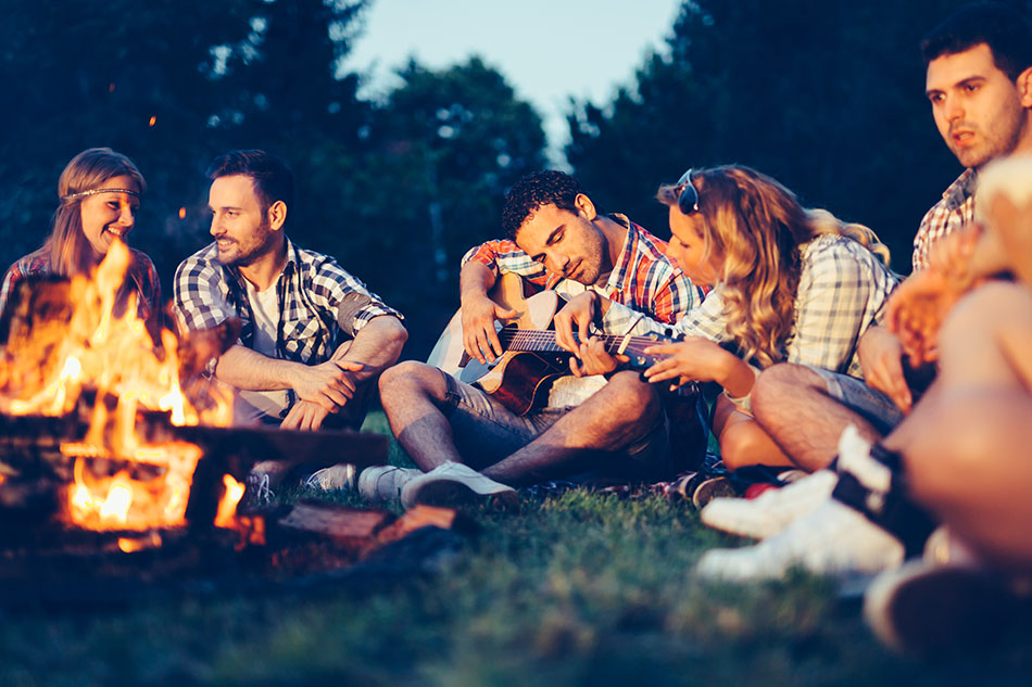 friends sitting around campfire