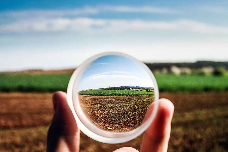 looking through a glass sphere to focus on a field