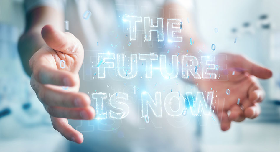 hands holding digital 'the future is now' sign