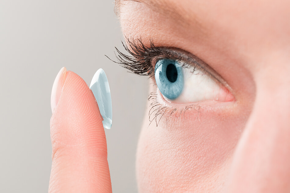 close up of woman’s eye as she inserts contact lens
