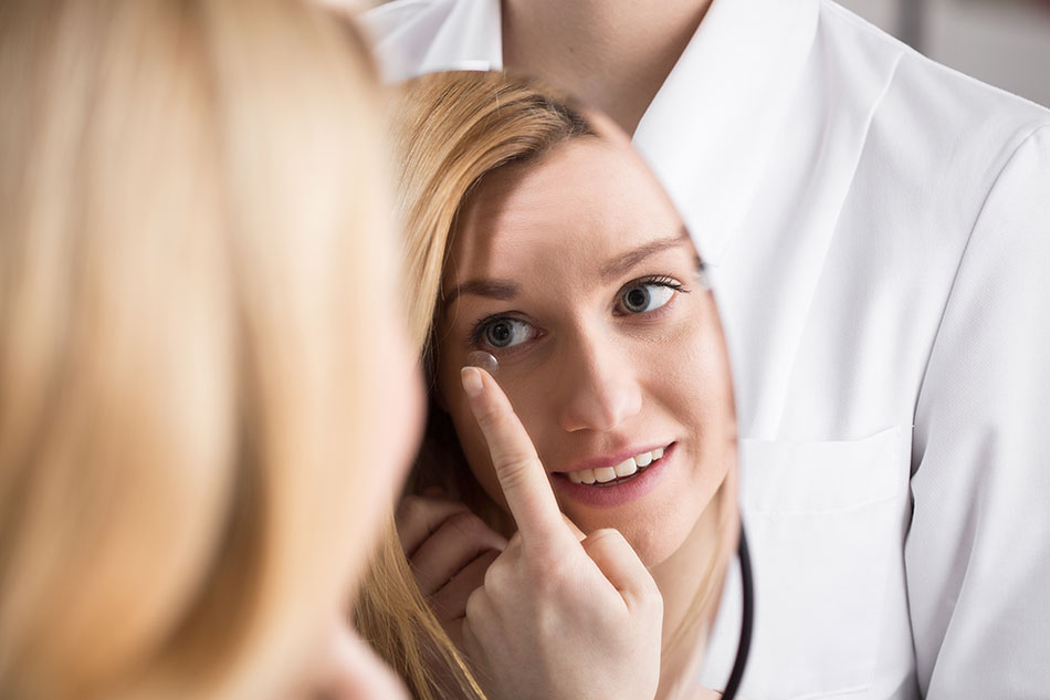 young woman learning how to insert contact lens