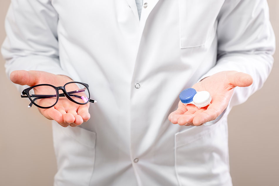 man choosing between contacts vs. glasses