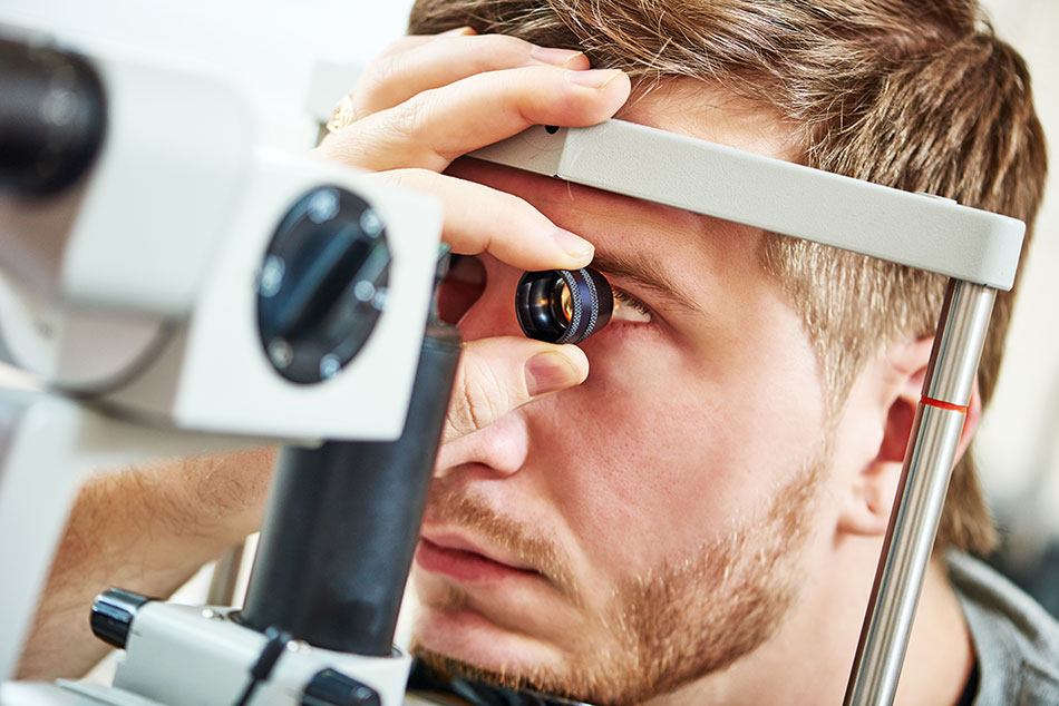 man having contact lens exam