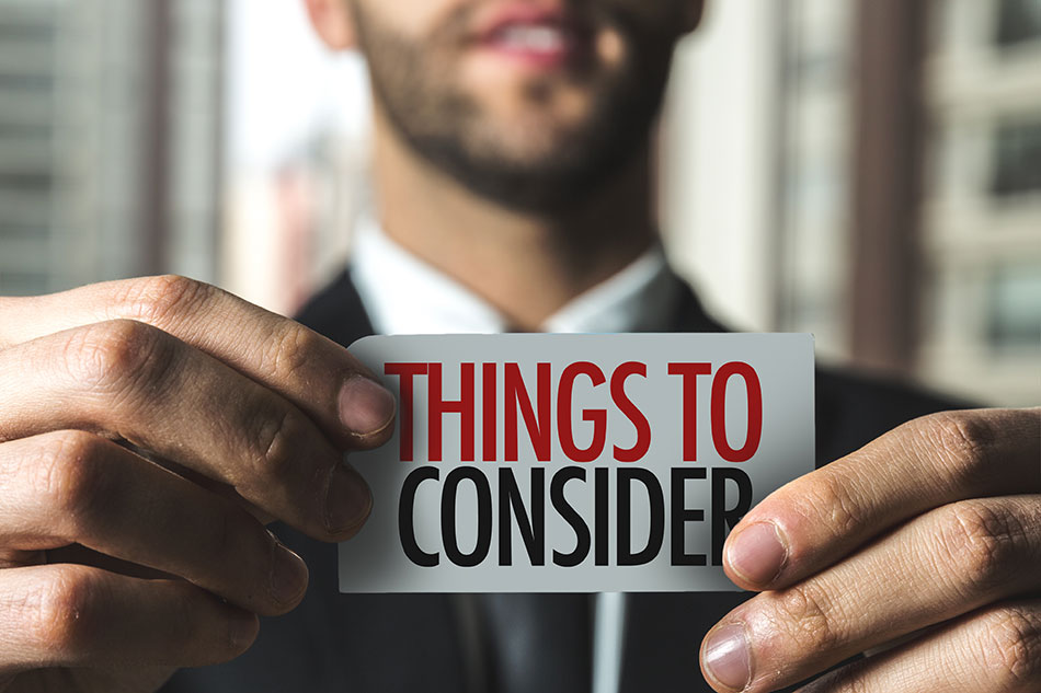 Man holding card saying things to consider