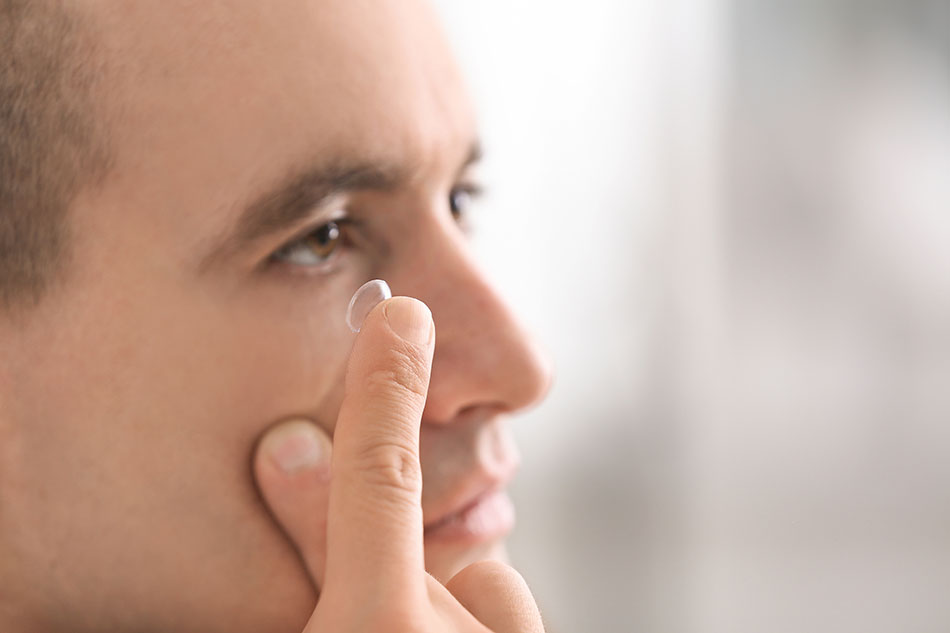 l'uomo che inserisce le lenti a contatto