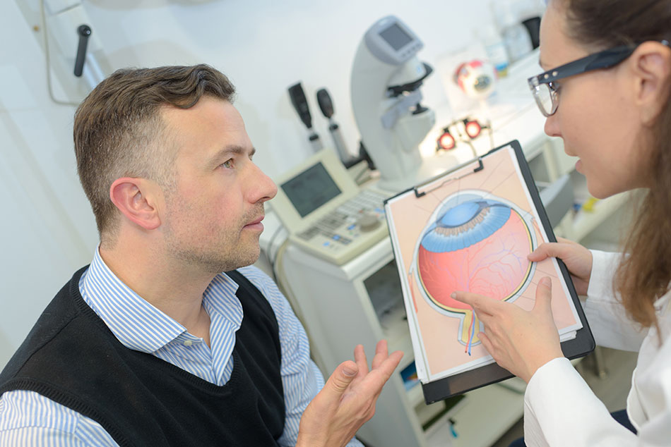 man learning about the eye from doctor