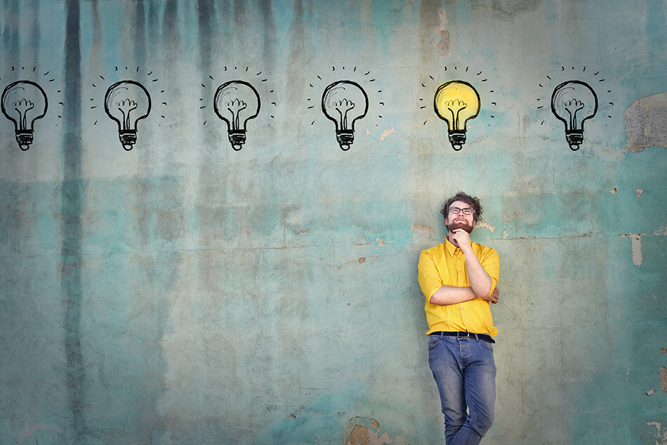 man reclining on a blue wall thinking of choices