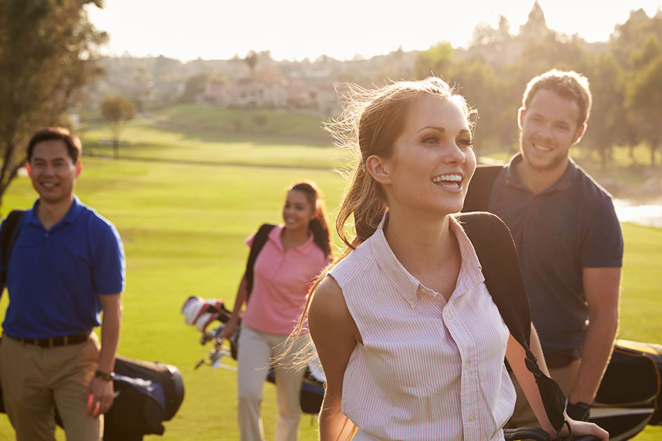 men and women having fun playing golf