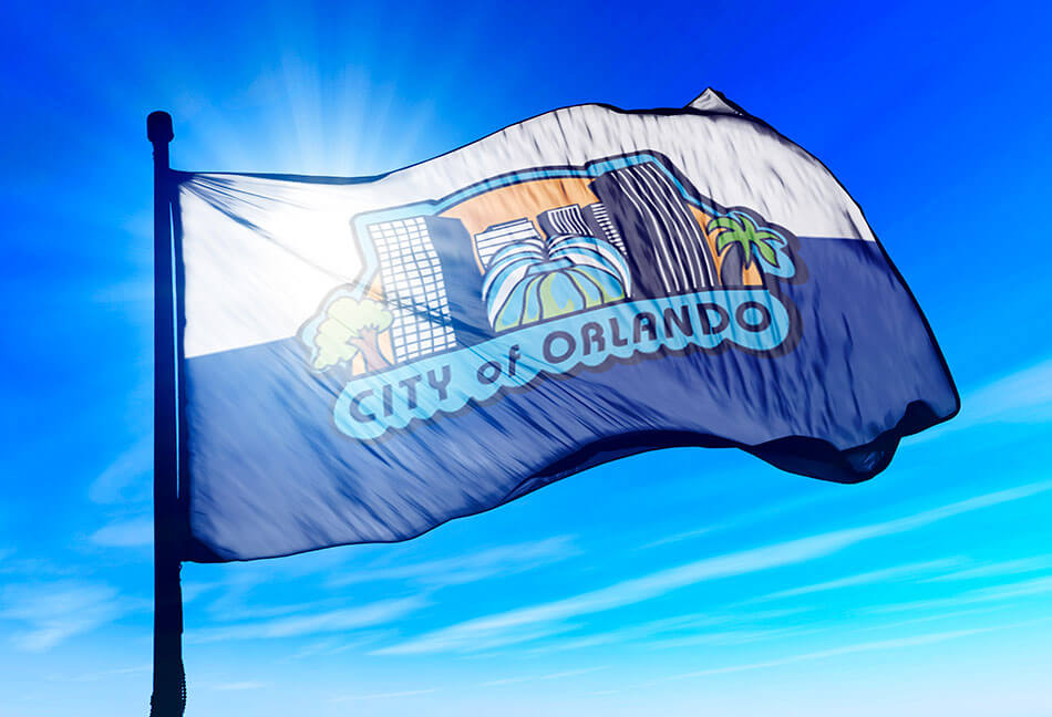 Orlando Flag with blue skies swaying in wind