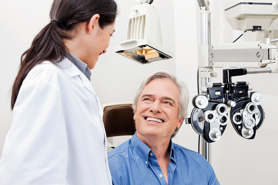 Optometrist with man getting regular eye exam