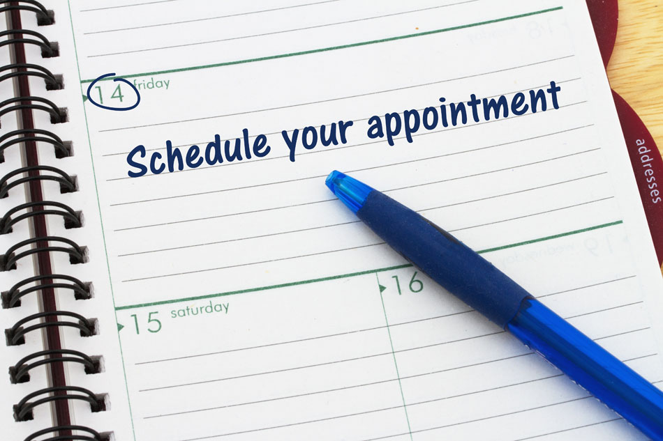 schedule your appointment written on planner with blue pen