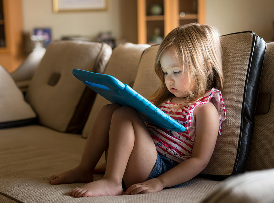 small girl looking at tablet screen