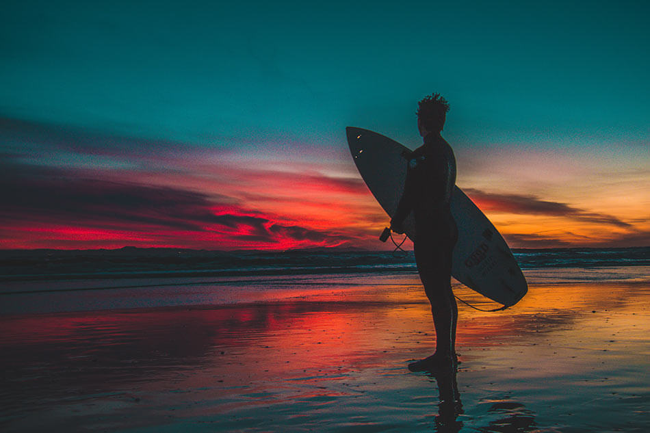 Sunset surfer on Vancouver Island beach