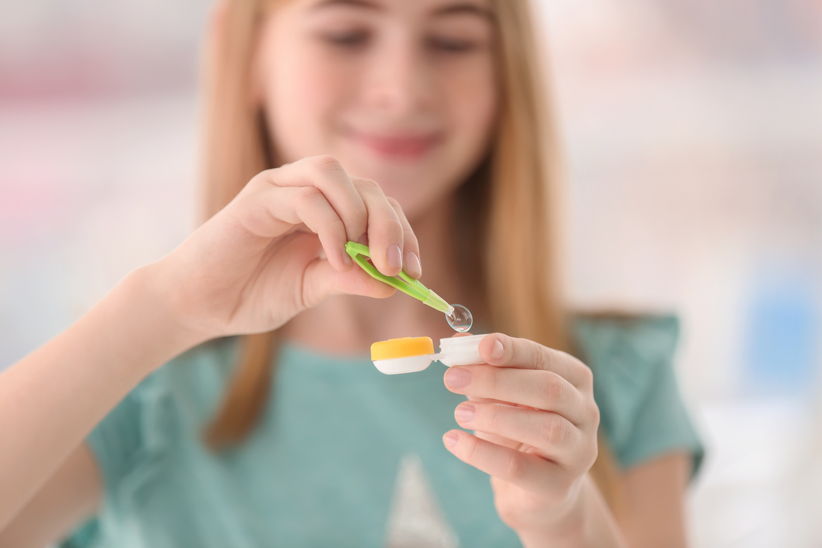 Teen girl taking care of contact lenses