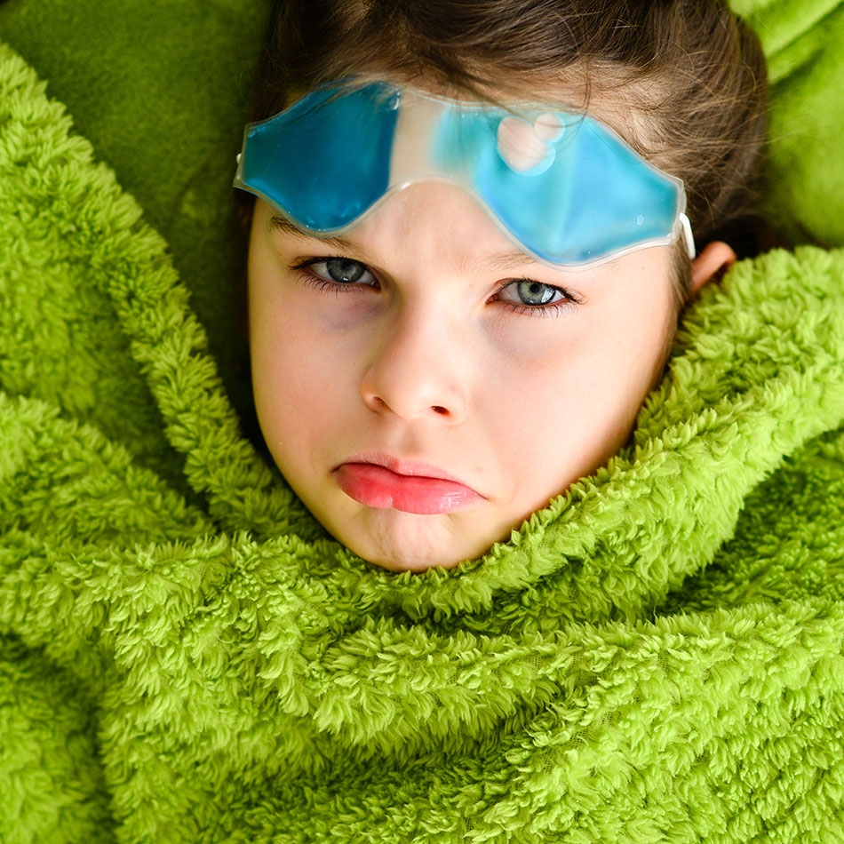 upset child with cool eye compress on forehead