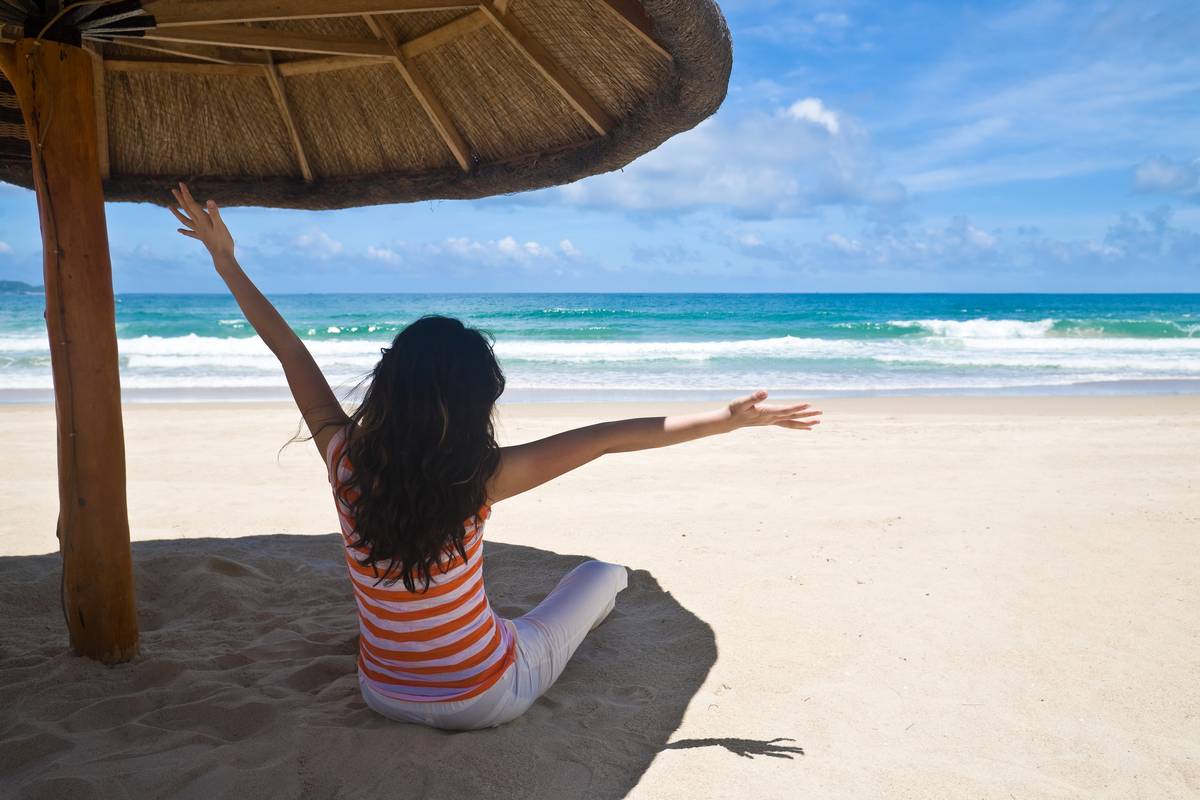 Woman on beach in the shade