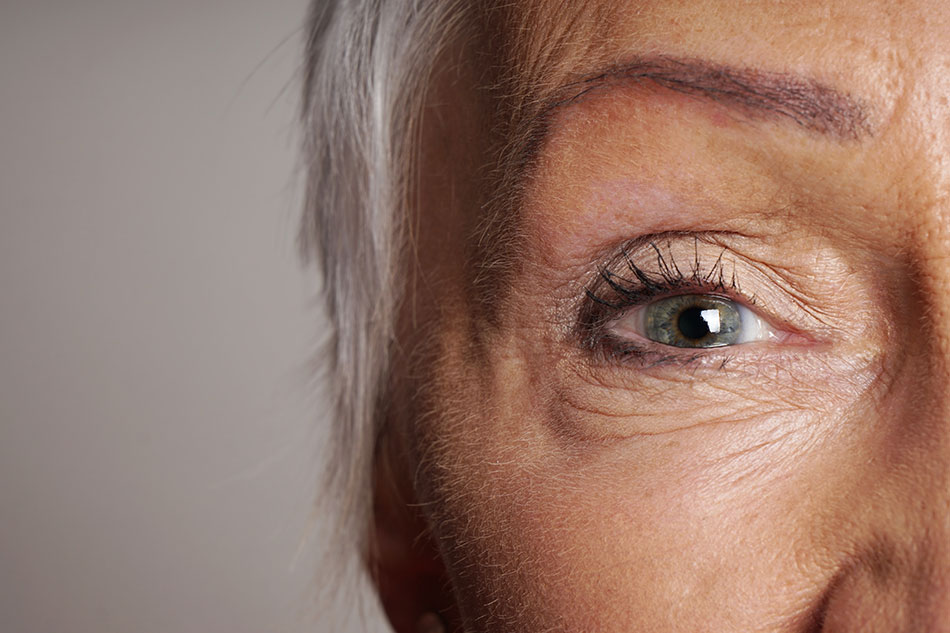 older woman with blue eyes and contact lens