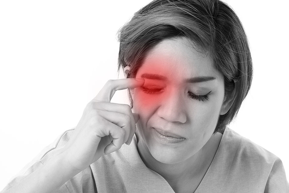 Woman suffering from irritated eyes black and white photo with red overlay