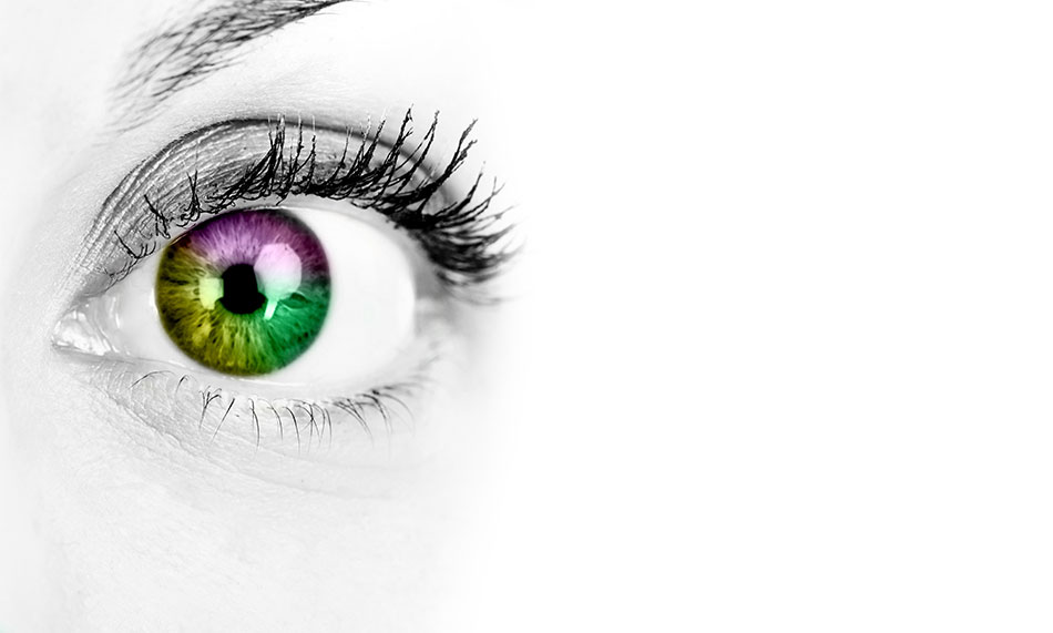 Woman’s eye on white background with multi-coloured contact lens