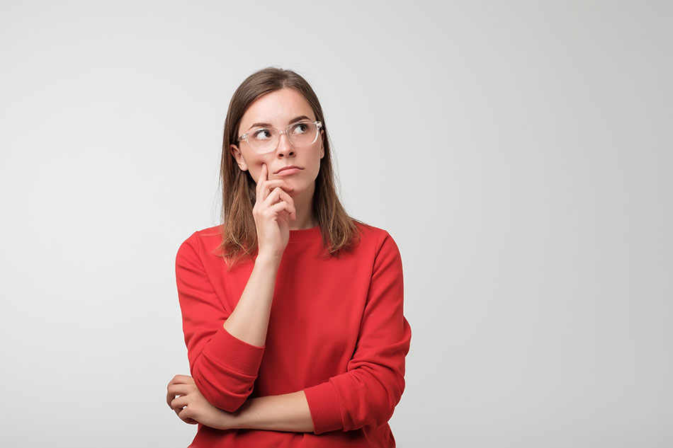 woman wearing glasses thinking about where to get contacts