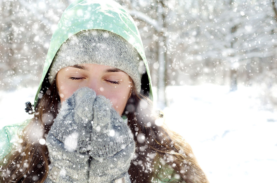 woman with gloves and hat in snow