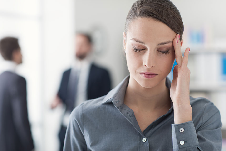 woman with headache at work