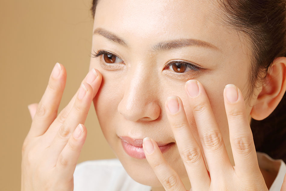 Woman massaging her eyelids