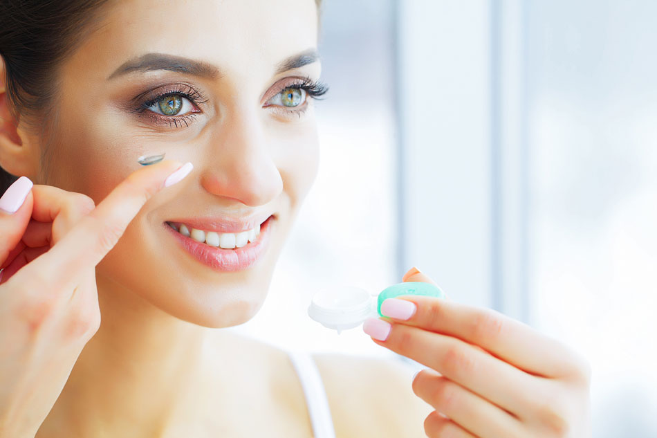 Woman putting in best coloured contacts for her skin tone