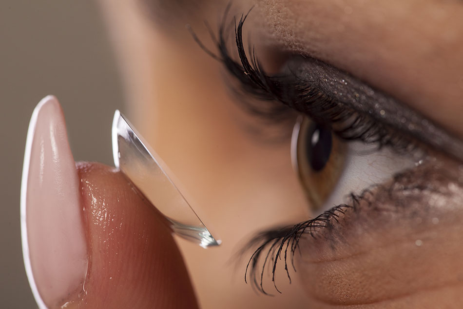 woman putting in contact with long nail