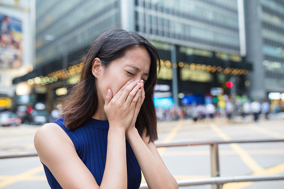 Woman sneezing from allergies