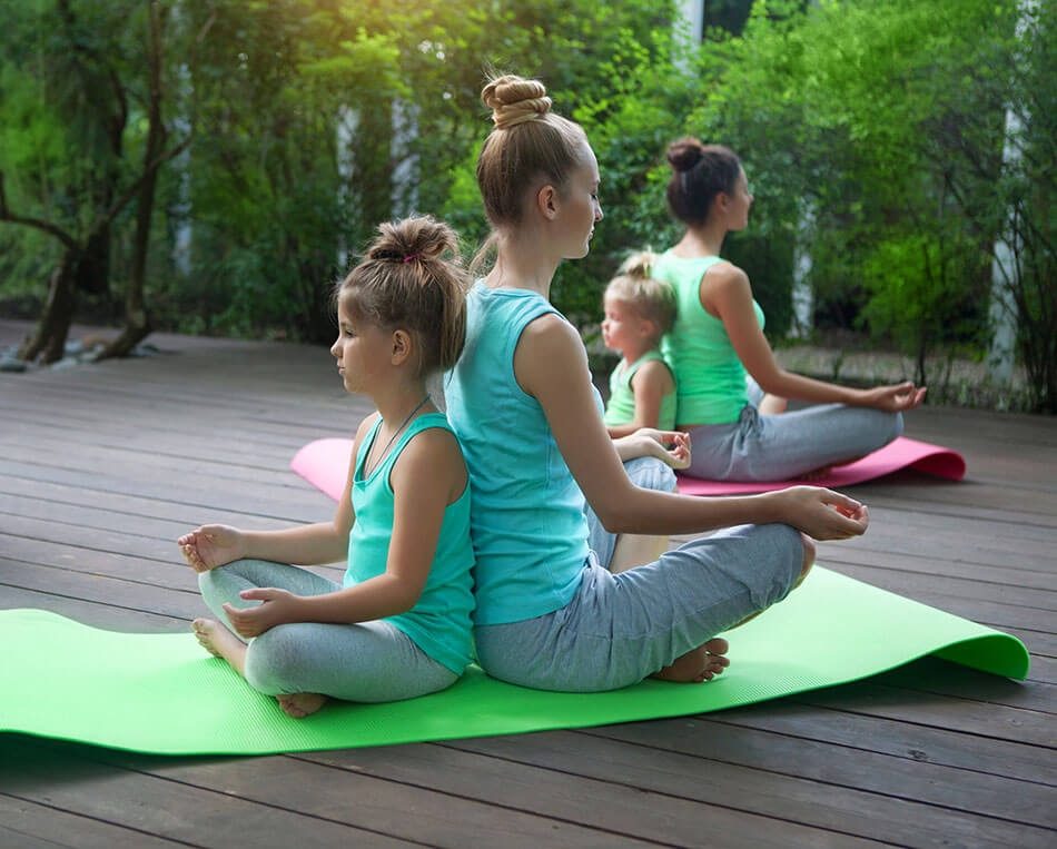 Diverse age group of women on yoga mats outside
