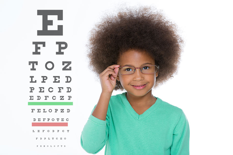 Young girl wearing glasses, eye chart in background