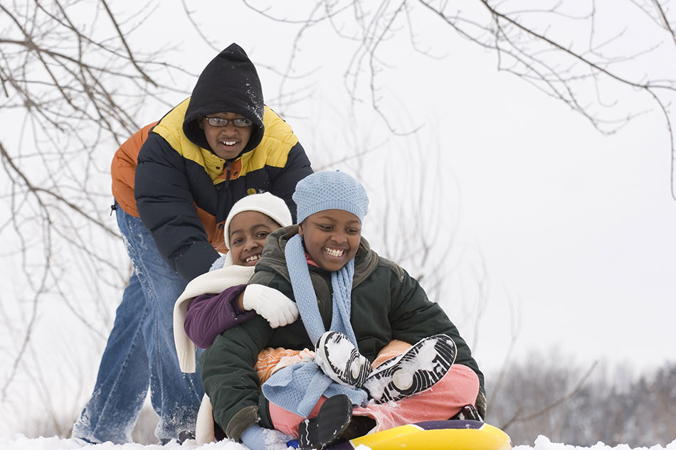 Young siblings having fun in snow