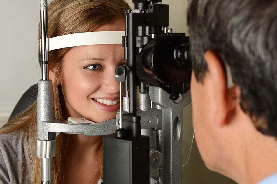 Young woman smiling during eye exam