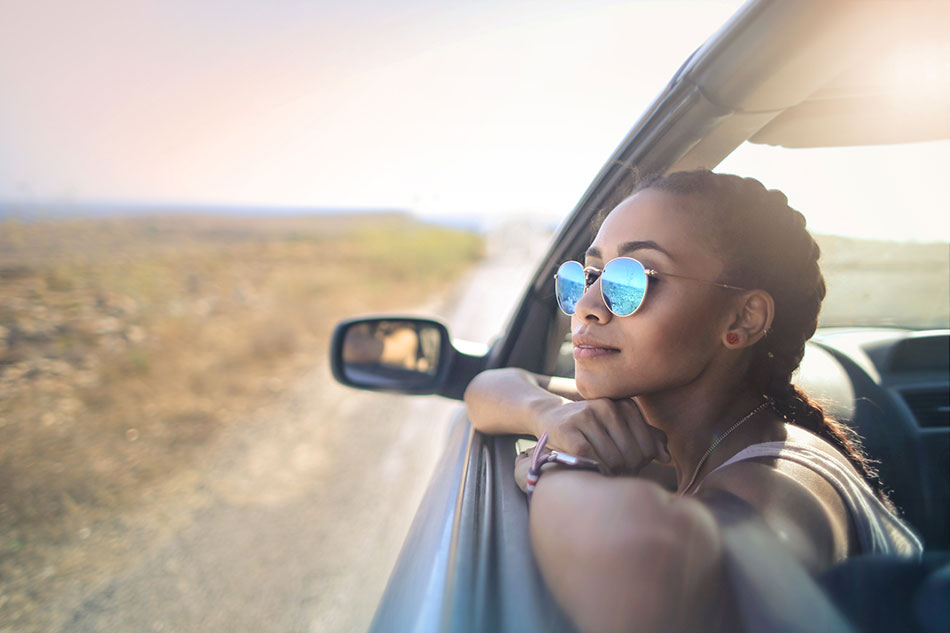 young woman wearing sunglasses in car