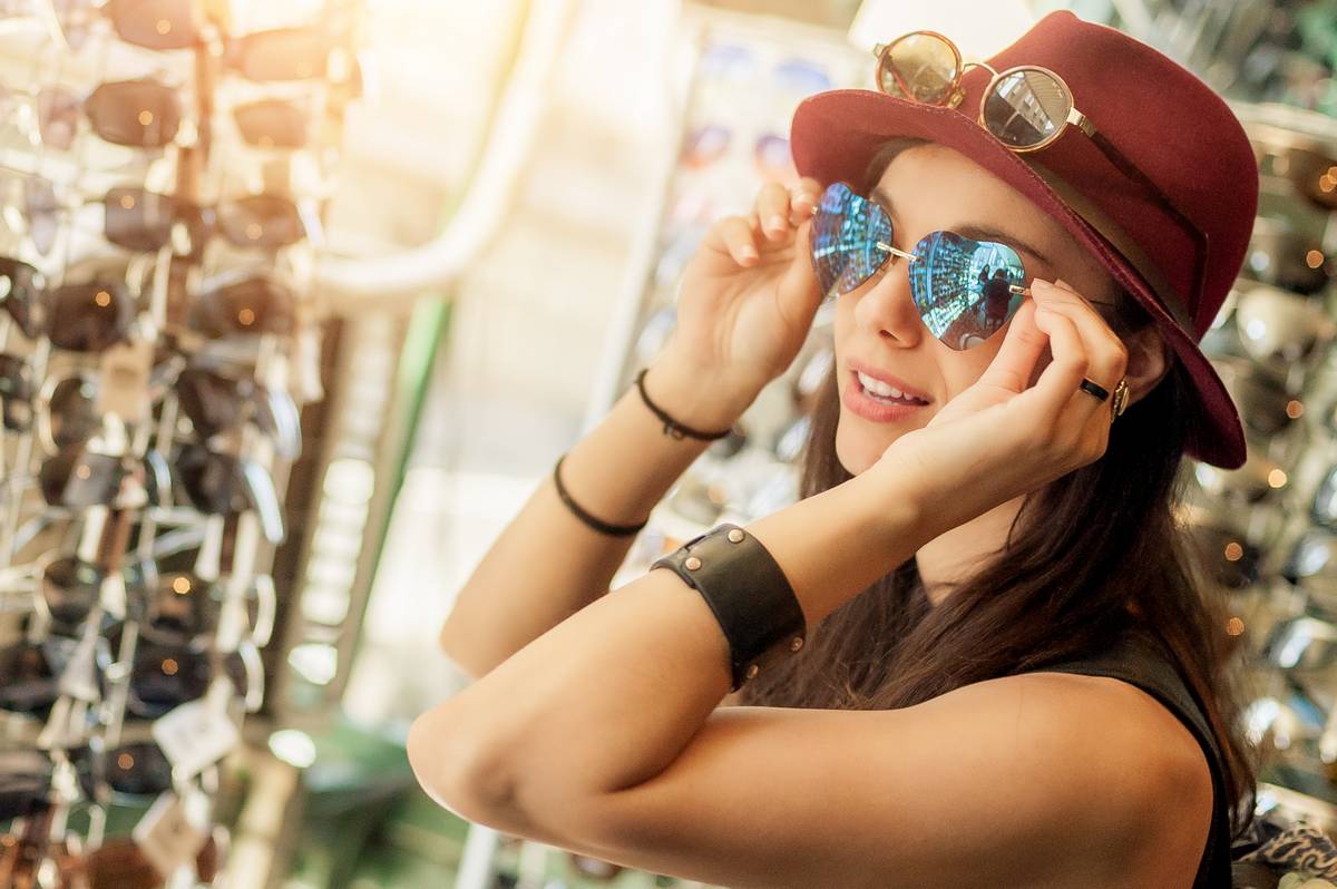 Young woman trying on sunglasses